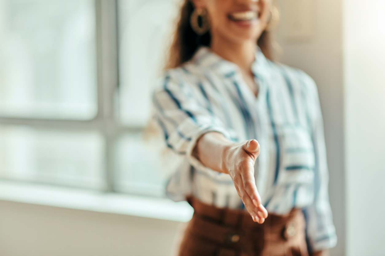 Woman offering handshake to new association member