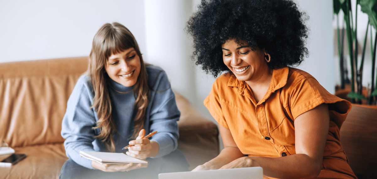 Two women using community on laptop